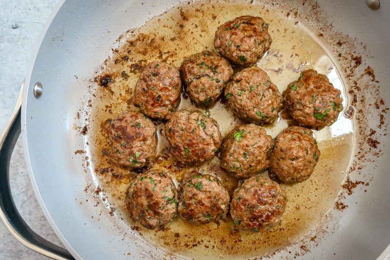 Browning the meatballs in a large skillet.