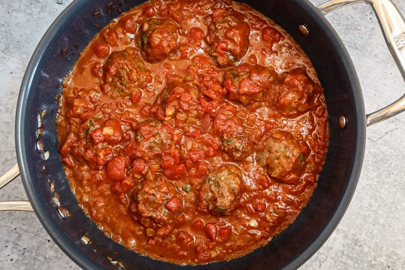 The meatballs are simmered in the tomato sauce.