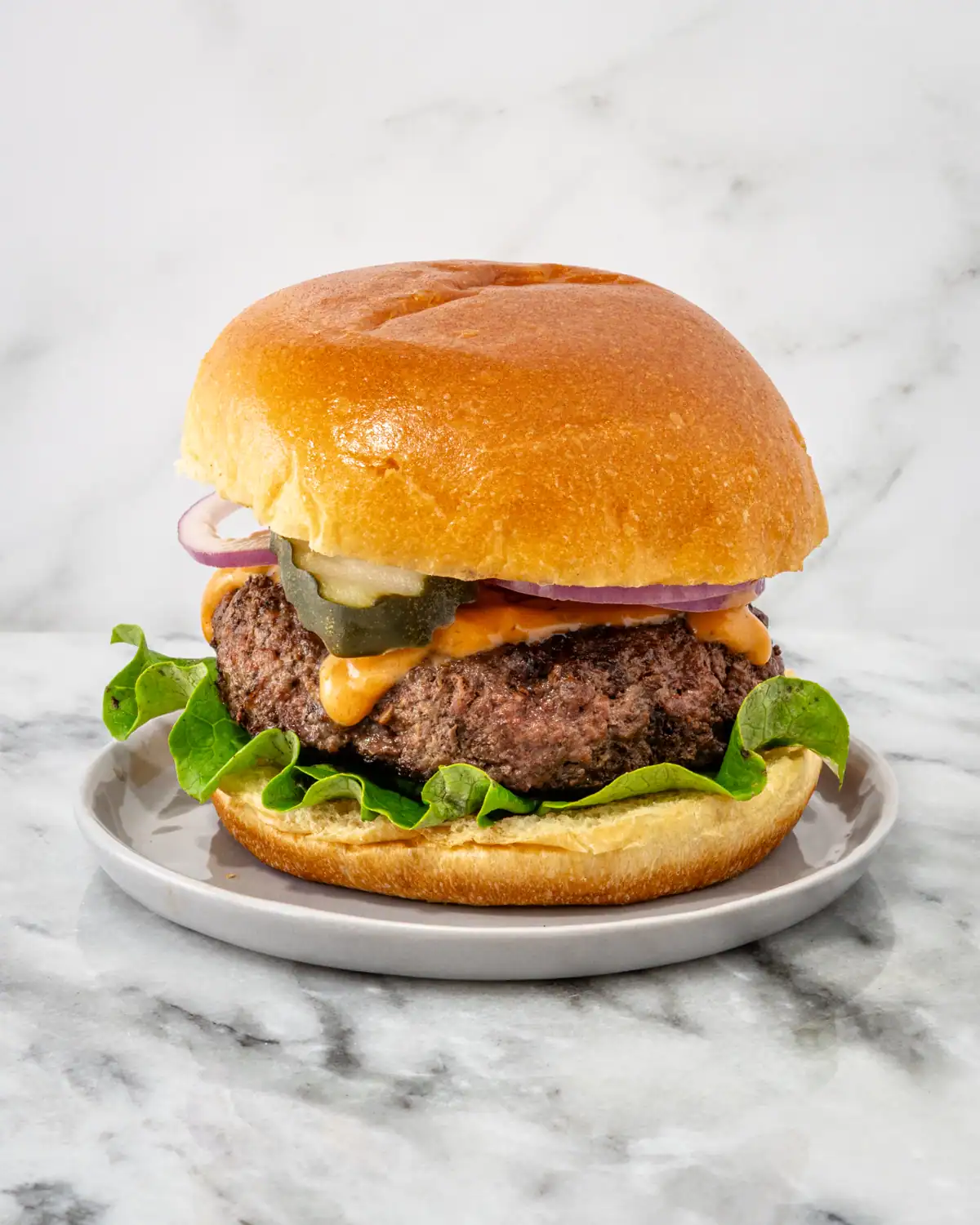 Juicy beef burger with fresh vegetables and melted cheese.