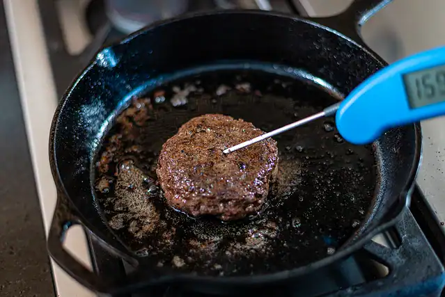 Checking burger temperature.