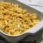 a baking dish with muenster and cheddar macaroni and cheese