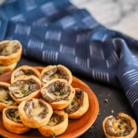 Tartlets with cream cheese pastry filled with mushroom duxelles and fontina cheese.