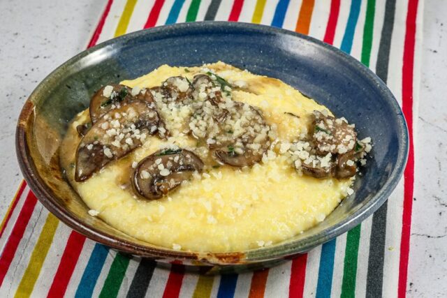 Mushrooms over polenta with a Parmesan cheese garnish.