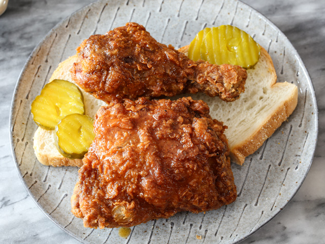 nashville hot chicken served on bread with pickles