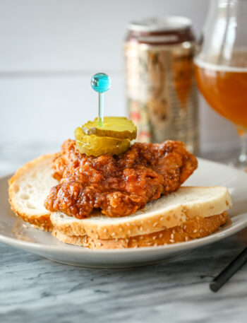 Nashville hot chicken on bread with pickles and beer