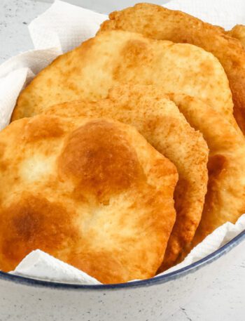Native American fry bread in a serving bowl with paper towels.