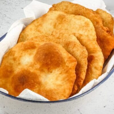 Native American fry bread in a serving bowl with paper towels.