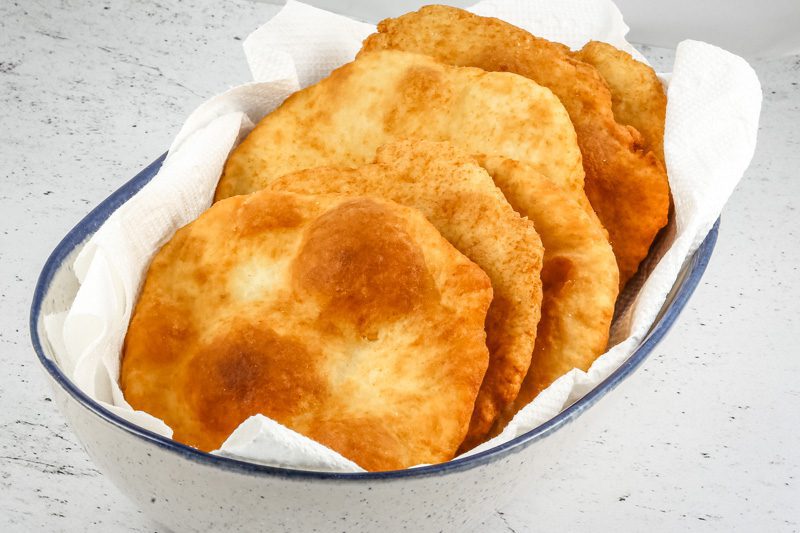 Native American fry bread in a serving bowl with paper towels.