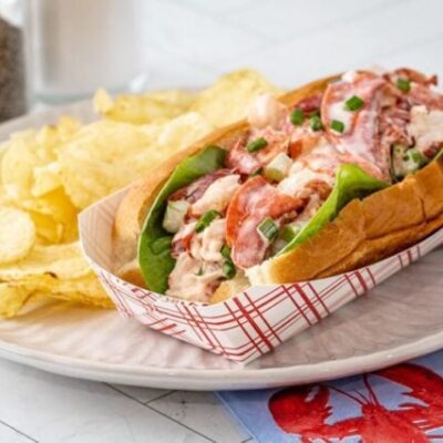 An authentic New England lobster roll in a New England hot dog roll.