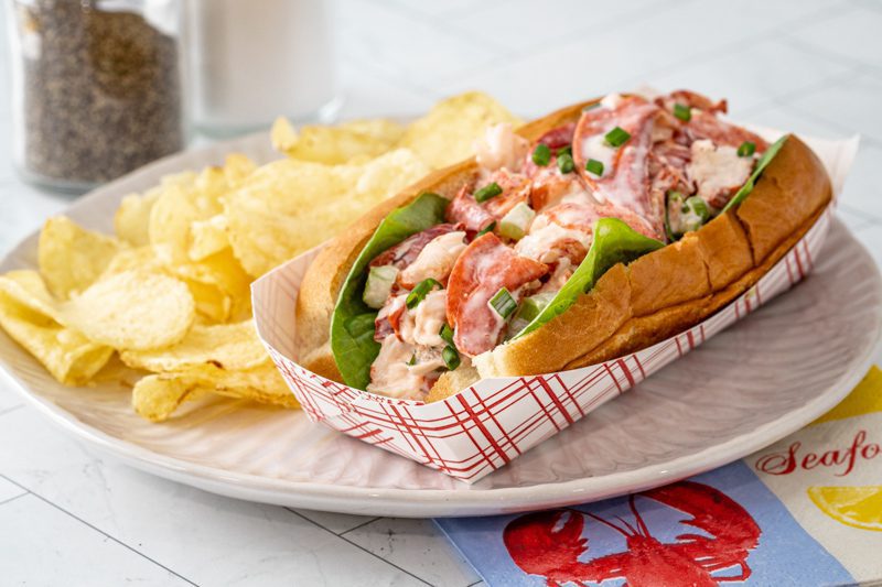 An authentic New England lobster roll in a New England hot dog roll.