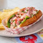A generously filled lobster roll in a toasted New England hot dog roll.