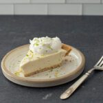 A slice of no-bake key lime cheesecake on a dessert plate.