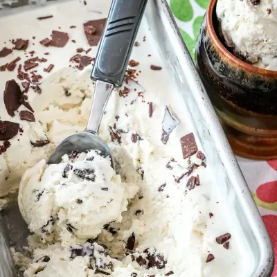 Creamy vanilla ice cream with chocolate shavings in a glass dish.