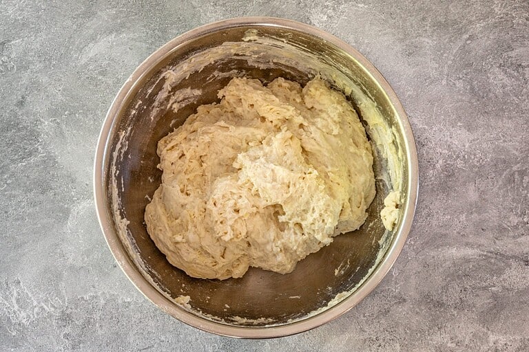 Creamy dough mixed in a metal bowl.
