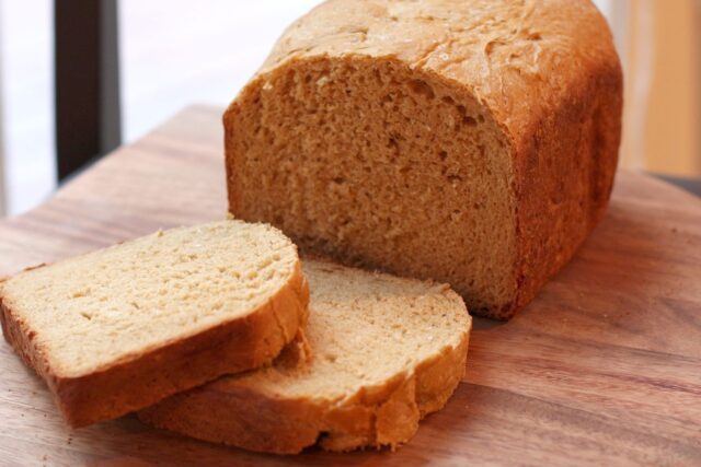 Sliced oatmeal bread on a cutting board.