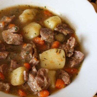 A bowl of old-fashioned beef stew with vegetables.