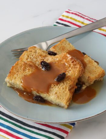 old-fashioned bread pudding on a plate with caramel sauce