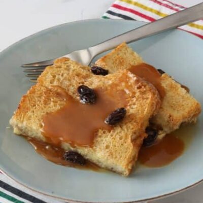 old-fashioned bread pudding on a plate with caramel sauce