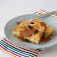 plate of bread pudding with raisins and a caramel sauce