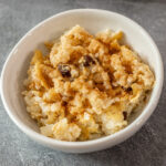 rice pudding in a bowl with raisins and cinnamon