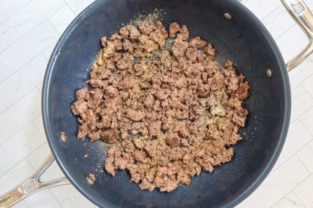 Browned ground beef in a deep skillet.