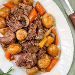 a pot roast with potatoes, carrots, and onion soup