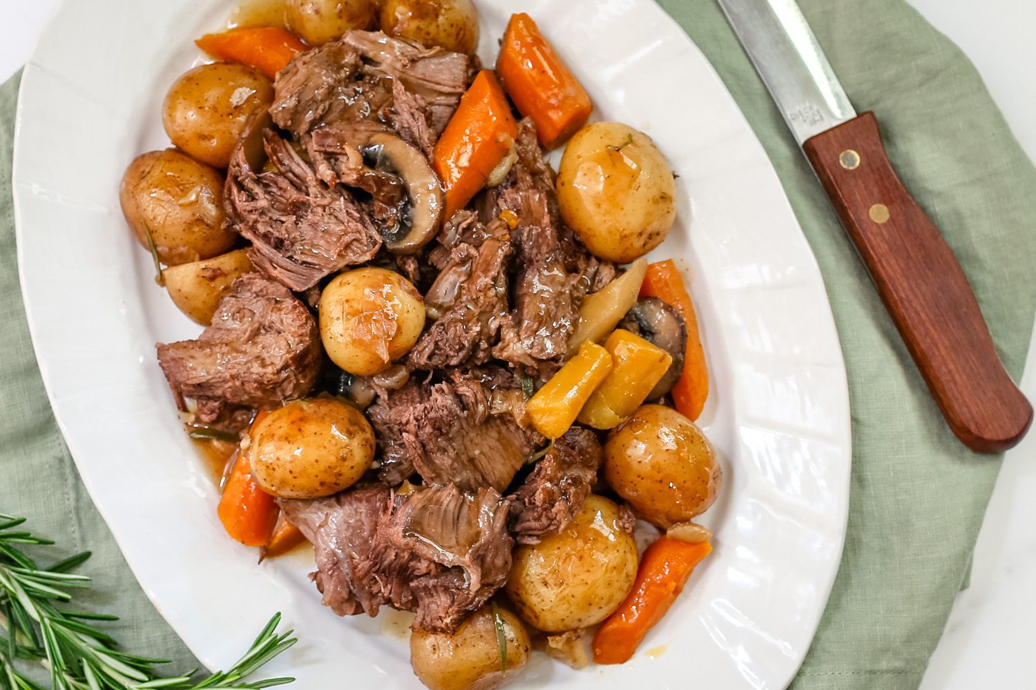 a pot roast with potatoes, carrots, and onion soup