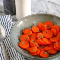 Orange glazed carrots with a garnish of chopped cilantro.