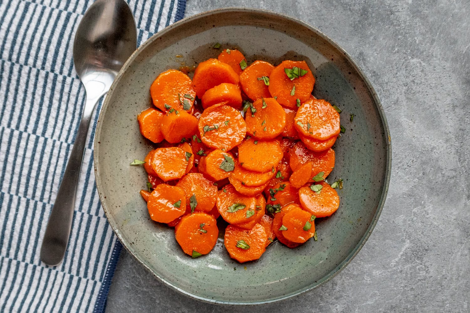 Orange glazed carrots ready to enjoy with cilantro garnish.