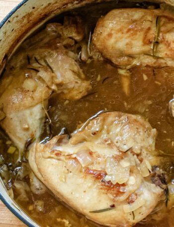 Oven braised chicken with rosemary, shown in the Dutch oven.