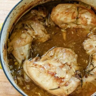 Oven braised chicken with rosemary, shown in the Dutch oven.