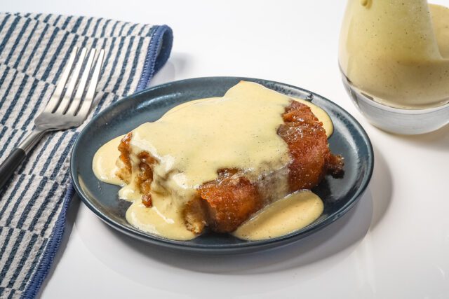 A serving of overnight French toast with creme anglaise sauce.