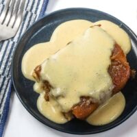 Golden fried chicken topped with creamy gravy.