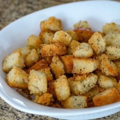 Seasoned croutons in a small bowl.