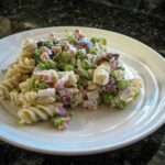 pasta, peas, and ham salad on a plate