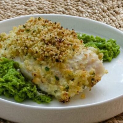 pea puree on a platewith a halibut filet