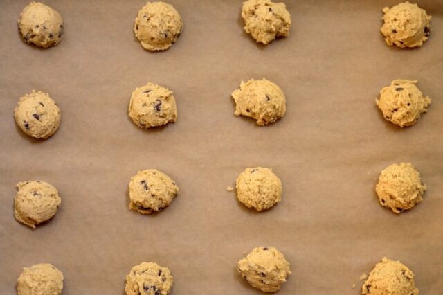 baking sheet with peanut butter chocolate chip cookie dough, ready to bake