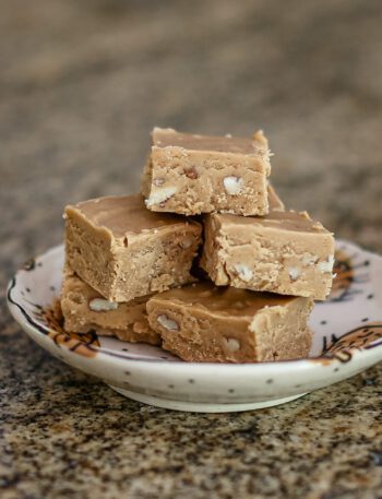 peanut butter fudge is stacked on a small plate