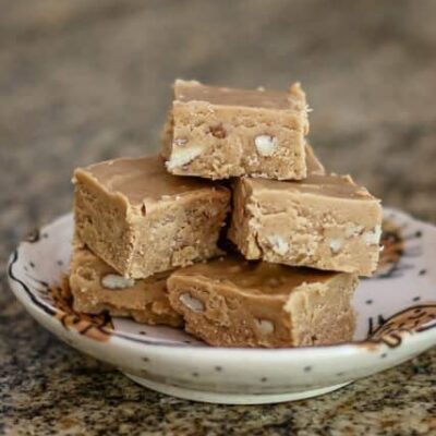 peanut butter fudge is stacked on a small plate