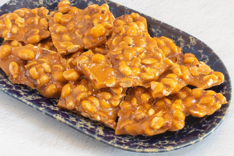 peanut brittle broken and served on a tray