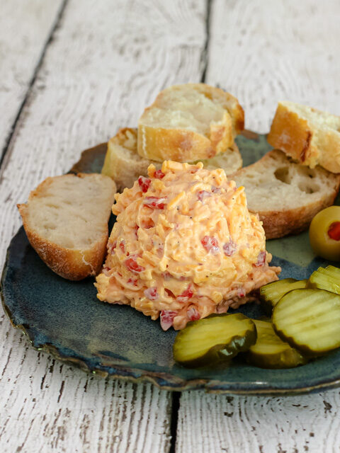 pimento cheese plate with pickles and baguette slices