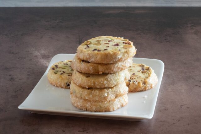 A stack of pistachio cranberry shortbread cookies