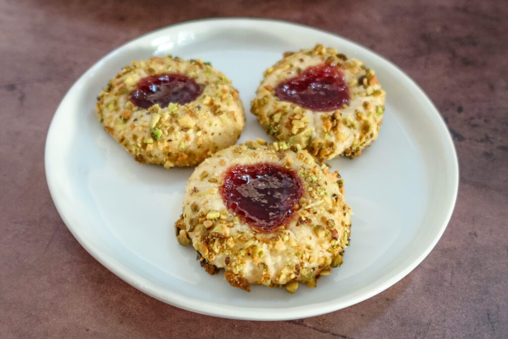 a plate of pistachio thumbprint cookies