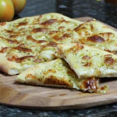 buttermilk pizza crust shown with green tomato pizza