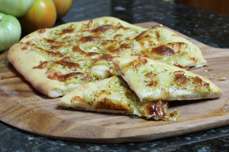 buttermilk pizza crust shown with green tomato pizza