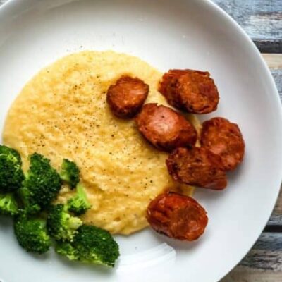 polenta with spicy andouille sausage on a plate