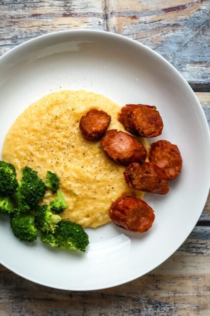 polenta with spicy andouille sausage on a plate