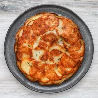 Golden baked scalloped potatoes layered with cheese.