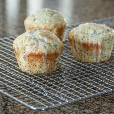 poppy seed muffins, glazed, on a cooling rack