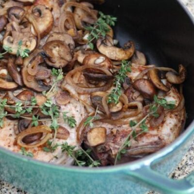 braised pork chops with mushrooms in a dutch oven